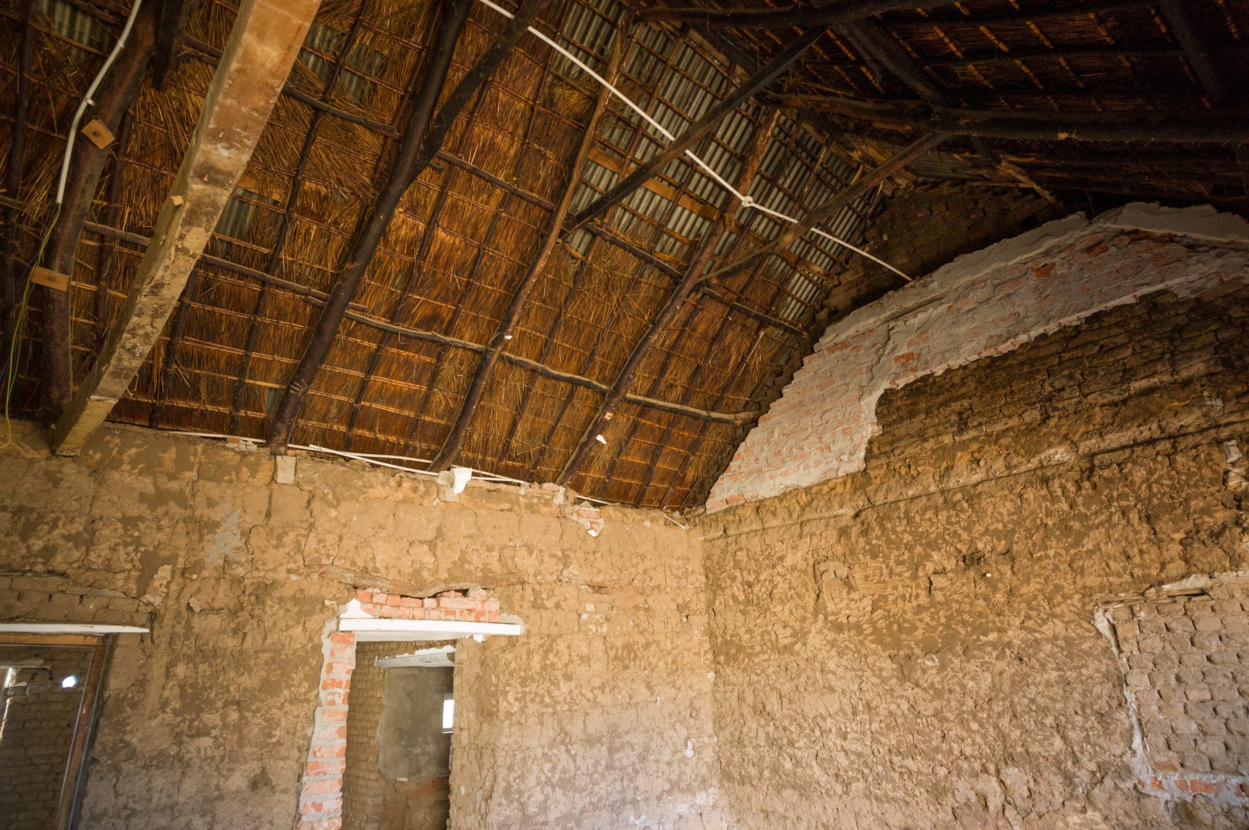 Buffelsdrift farmstead under restoration — reed and thatch ceiling over clay wall, Ladismith, Klein Karoo